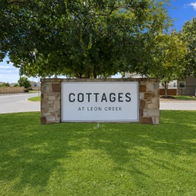 an entrance with a sign in a lawn