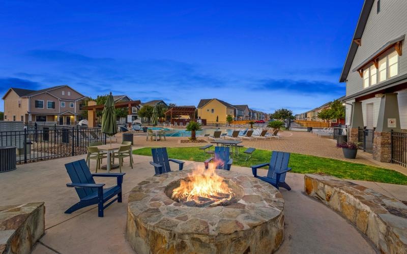 a fire pit surrounded by lawn chairs