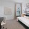 a living room with a green daybed and desk